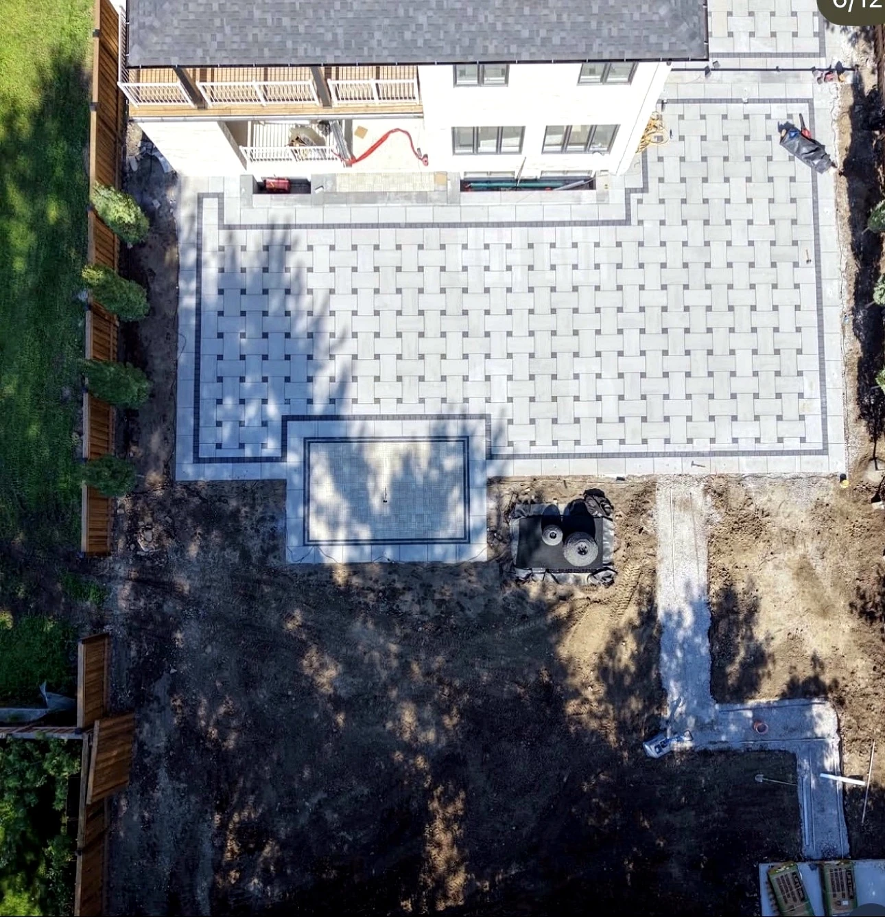 Aerial view of basketweave interlock patio with charcoal accents — completed Pisces project in Toronto
