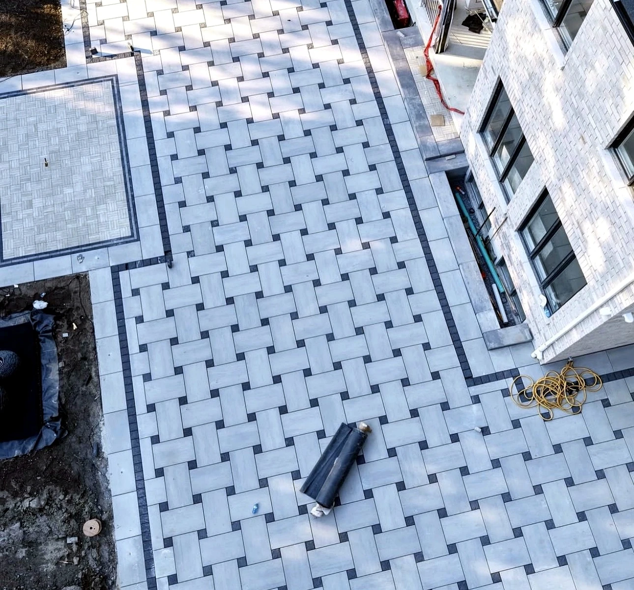 Drone photo of backyard interlock patio with charcoal border frame — completed Pisces project in Toronto