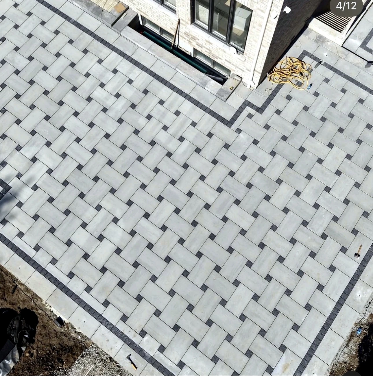Aerial view of basketweave paver layout with charcoal inlay accents — completed Pisces project in Toronto
