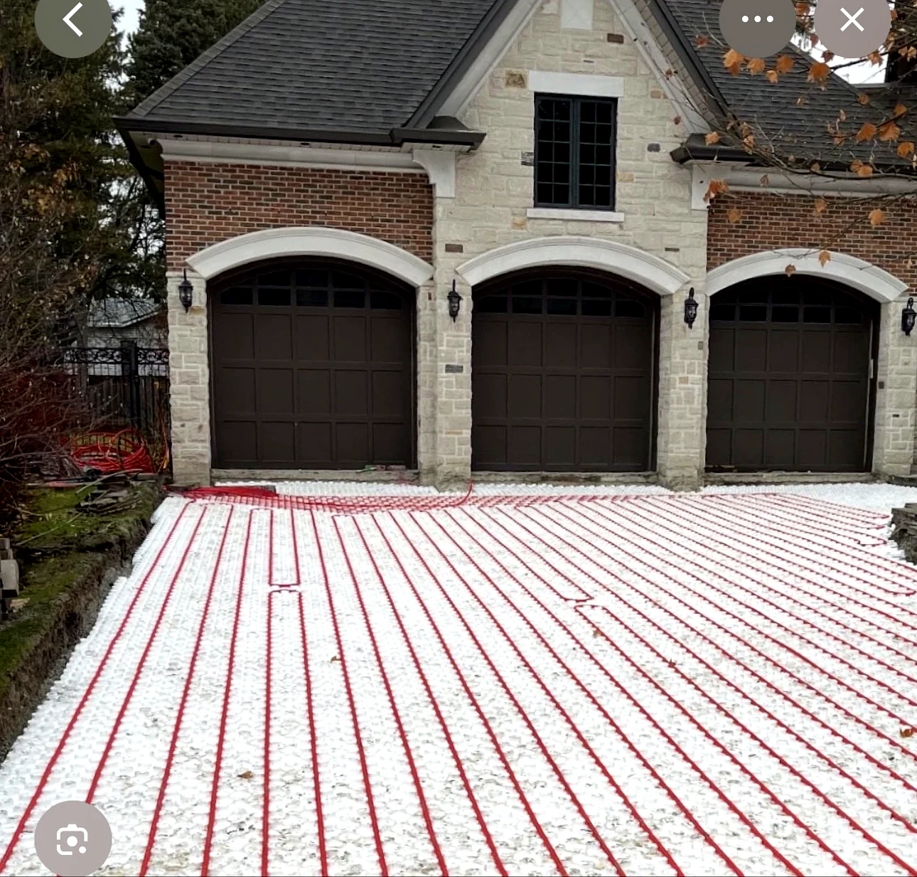 Real Pisces work — hydronic snow-melting pipes laid in even runs on a residential driveway