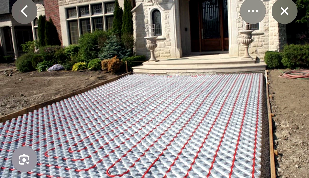 Real Pisces work — hydronic snow-melting pipe installation on a front entrance walkway