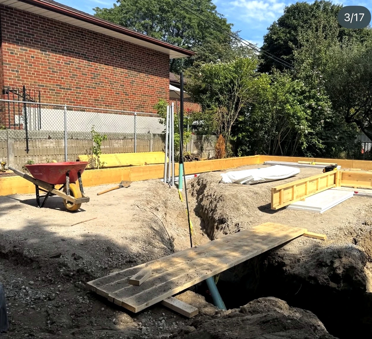 Real Pisces jobsite: foundation formwork with a utility trench and pipe below grade